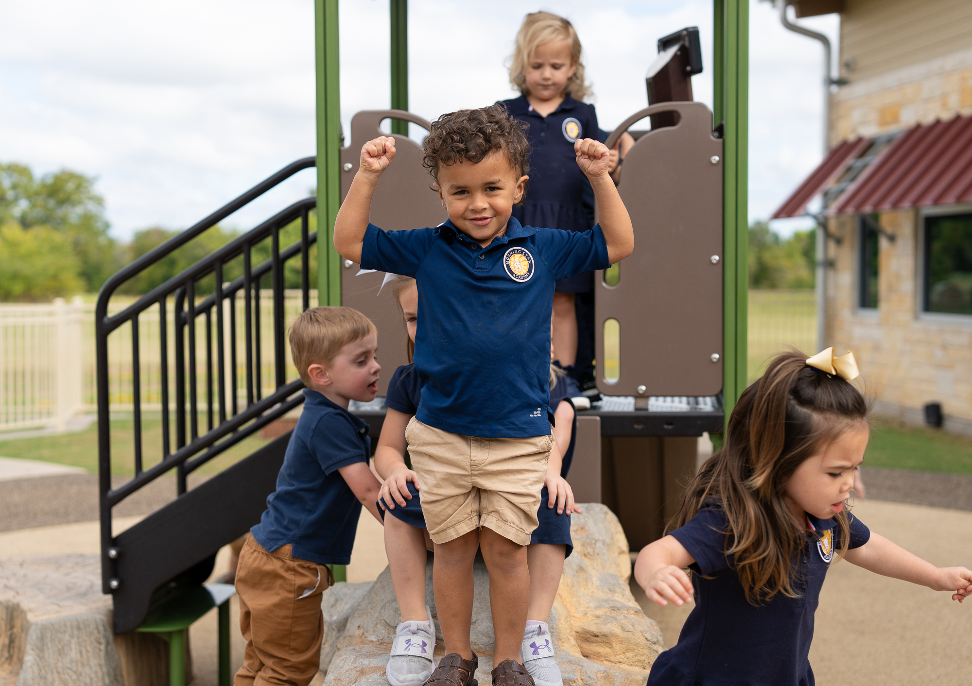 Students play together on the playground outdoors during their recess period