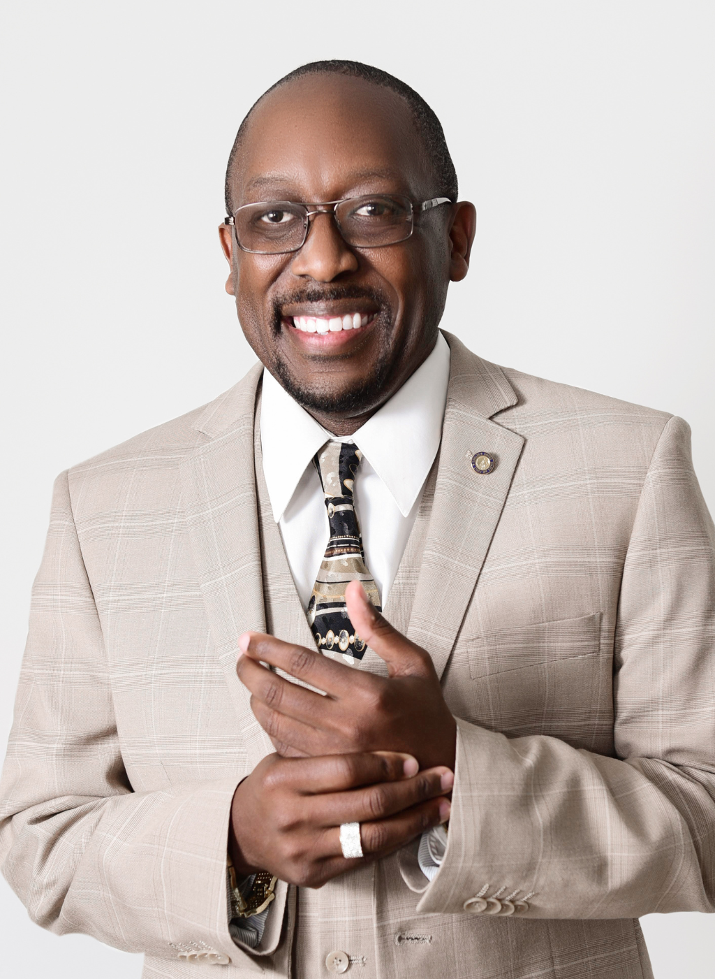 Lee Wright, smiling and wearing a suit, possibly associated with Beauty From Ashes Youth Leadership Academy.
