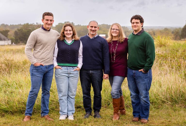 Family of five in a field, possibly part of Our Team.