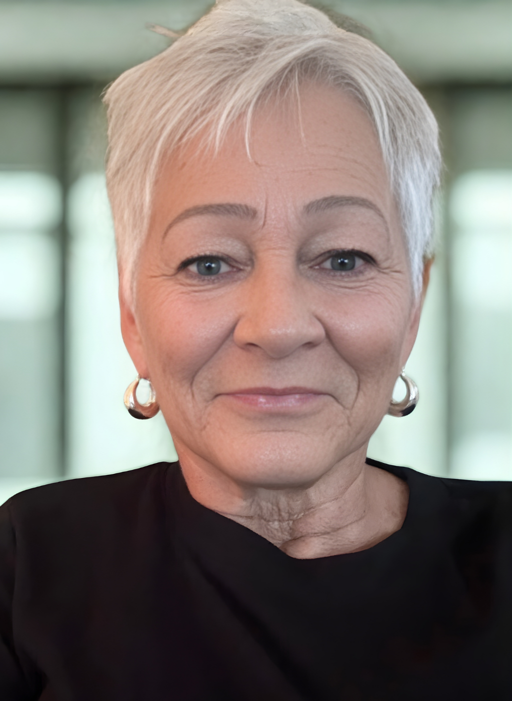 Close-up of Terrie Haney, a woman with short gray hair and a black top, smiling.