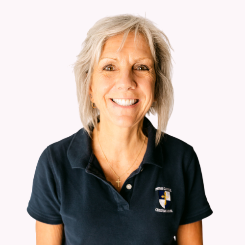 Isobel Bolt, smiling, wearing a dark blue polo shirt with Philos Classical Christian School logo.
