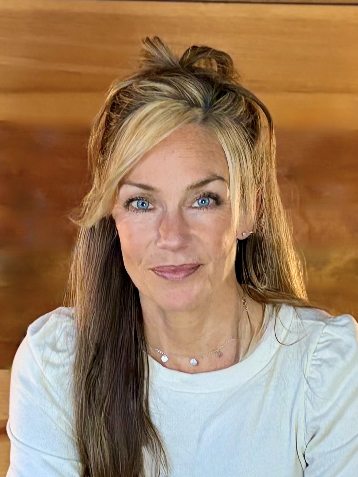 Heather Wilkinson, a woman with striking blue eyes and blonde-streaked hair, smiles warmly.