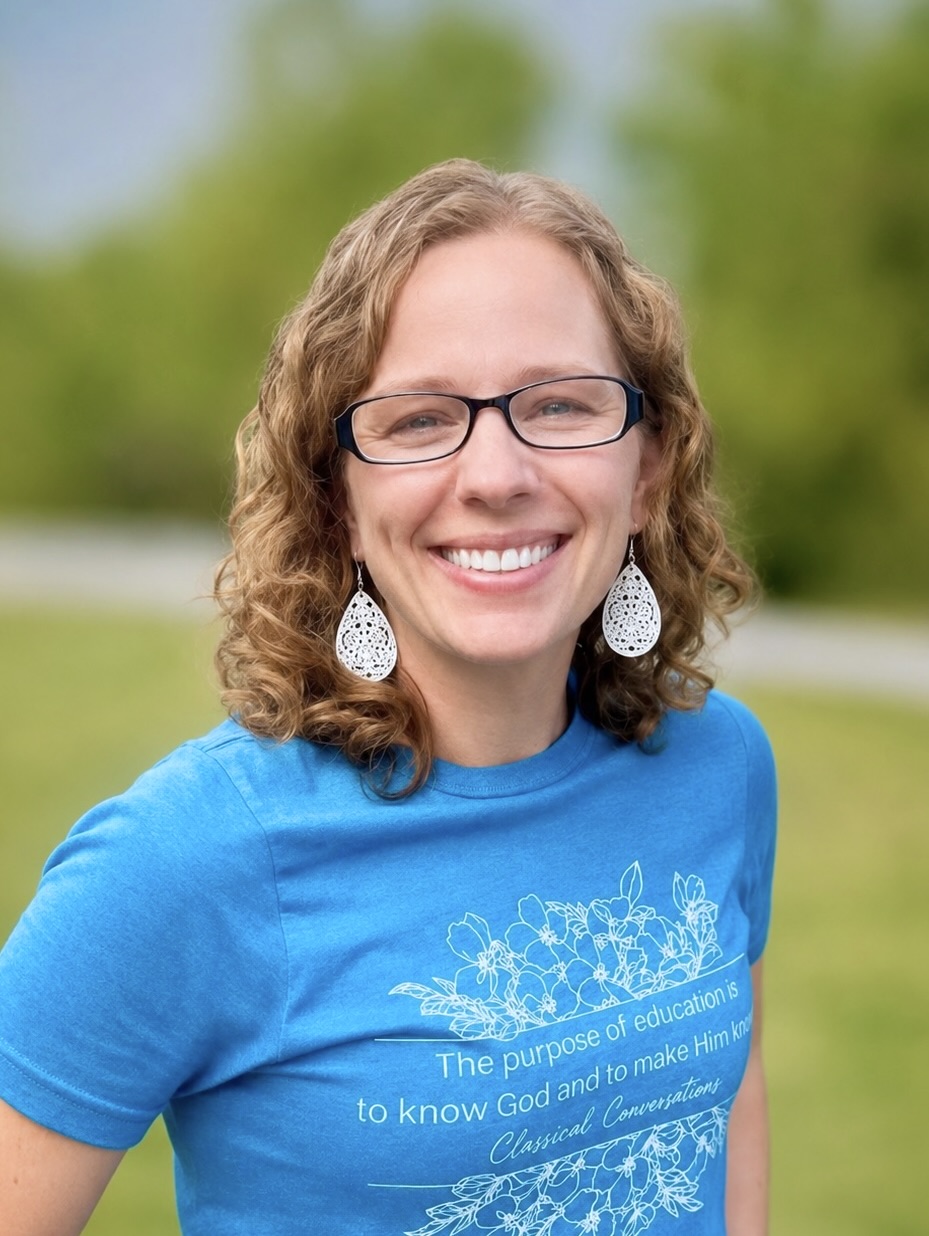 Tiffany Berg, smiling in a blue shirt with floral design.